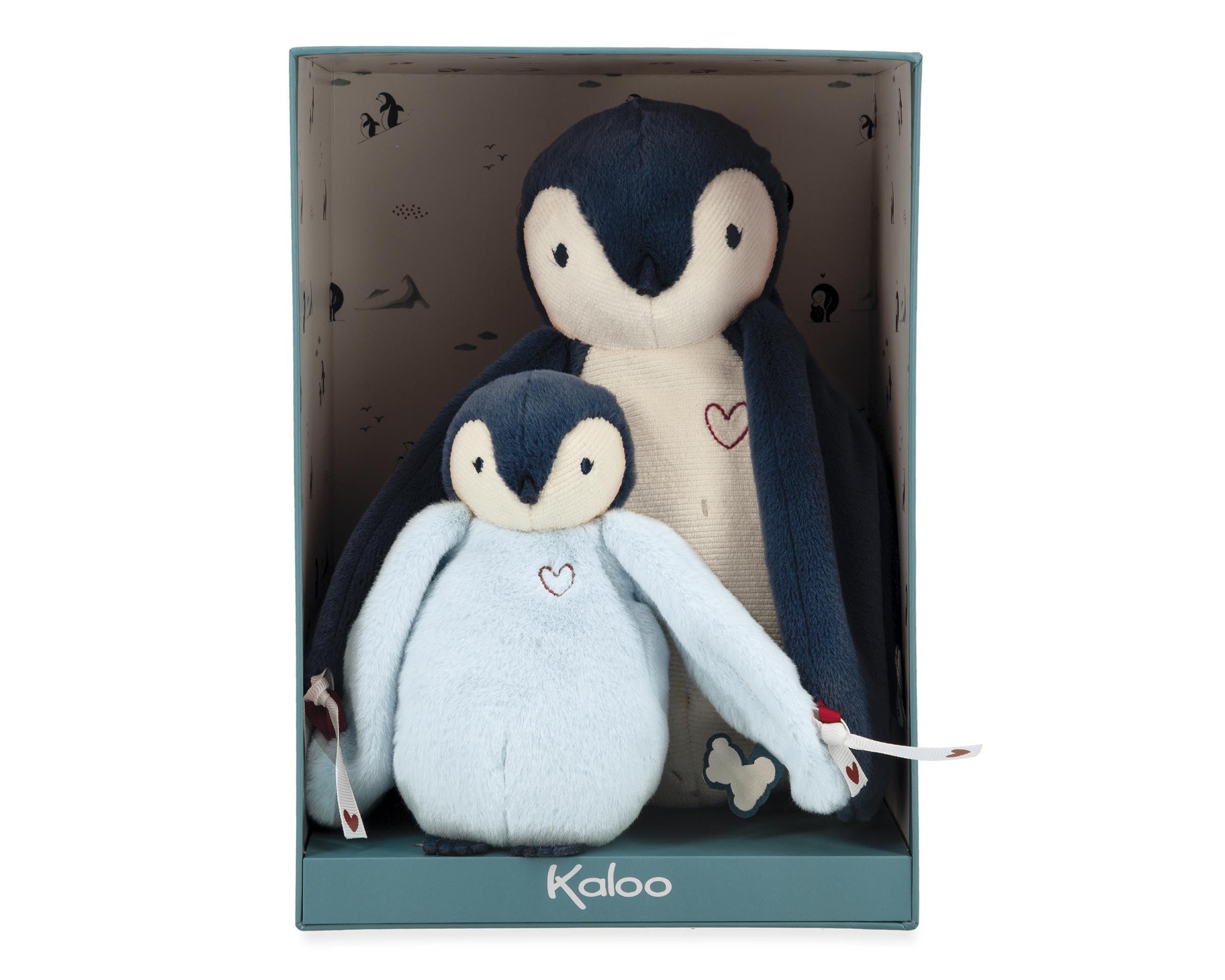 Two plush penguins in a box with 'Kaloo' branding on a white background