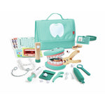 A Little Dentist Playset with a green carrying case, various dental tools, and pretend teeth laid out on a white background.